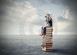 Photographer on a pile of books