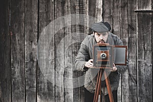 Photographer prepares for shooting on large format camera. Concept - photography of the 1930s-1950s