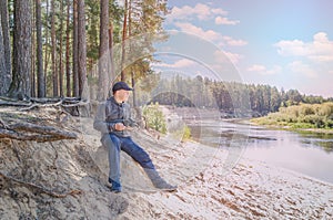 Photographer relaxes in nature near the river