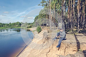 Photographer relaxes in nature near the river