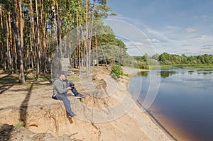 Photographer relaxes in nature near the river