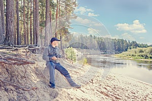 Photographer relaxes in nature near the river