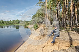 Photographer relaxes in nature near the river