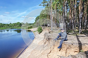 Photographer relaxes in nature near the river