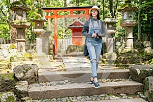 Photographer relaxing walking in front of Torii