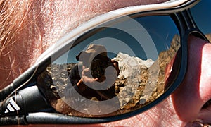 Photographer rereflecting on glasses