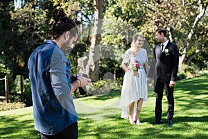 Photographer reviewing photographs on digital camera