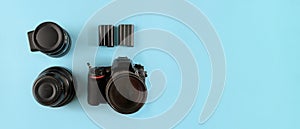 Photographer`s equipment.Flat lay composition with photographer`s equipment and accessories on blue background