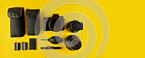 Photographer`s equipment.Flat lay composition with photographer`s equipment and accessories on yellow background