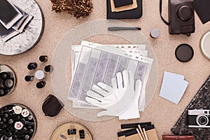 Photographer's table with negatives and white gloves. Directly above.