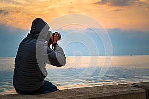 Photographer in seaside with beautiful sunrise background. Khobar Corniche -Saudi Arabia