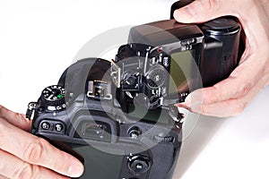 Photographer set external flash on digital SLR camera