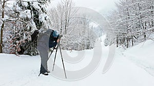 The photographer shoot a mountain forest in the Carpathians in rainy and snowy weather