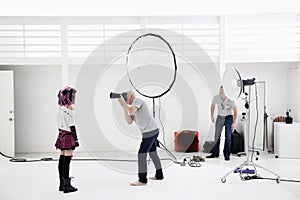 Photographer shooting fashion model in photo shoot photo