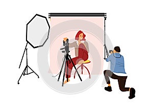 Photographer shooting model in studio. Photo session concept. Man taking pictures with professional camera and light