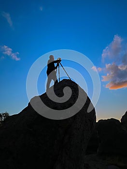 Photographer shooting sunset shot at City of Rocks, New Mexico USA