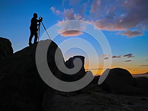 Photographer shooting sunset shot at City of Rocks, New Mexico USA