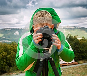 Photographer shoots with DSLR Camera using tripod