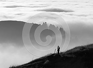 Photographer silhouette over fog