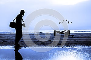 Photographer silhouette shooting near the beach