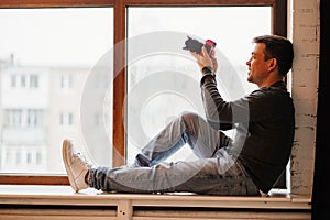 photographer sits on windowsills and takes pictures. training in photography. photo