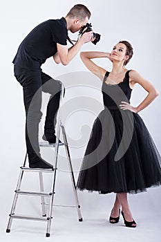 Photographer standing on the ladder and taking a photo