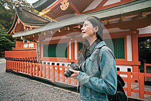 Photographer standing near red wooden temple