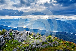 Photographer take a photo and standing on top of the rock in nature. Travel concept.