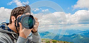 Photographer take pictures Snapshot with camera.Men& x27;s hands held camera closeup. Man hand holding camera looking