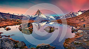 Photographer takes picture of Stellisee lake with Matterhorn peak on background.