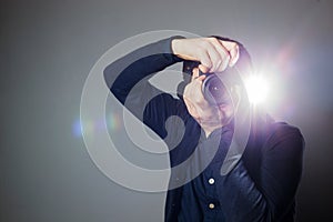 Photographer takes a picture in the studio using a flash photo