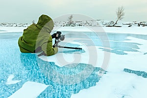 Photographer takes pictures bubbles of methane gas frozen into clear ice lake baikal, russia