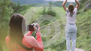 A photographer takes a video from a mountain hike