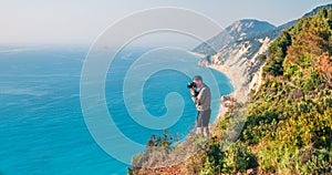 Photographer takeÑ– picture from the top of the cliff on west coast of Lefkada island, Greece, Europe. Spectacular morning