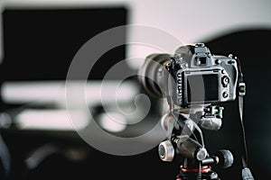 photographer taking indoor pictures of newly renovated office. Camera on tripod details