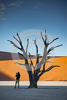Photographer taking photo in deadvlei, Namibia