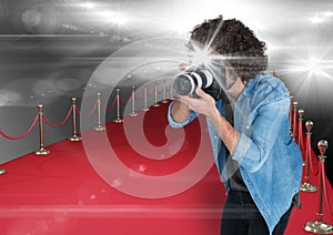 photographer taking a photo with flash in the red carpet. Flares everywhere