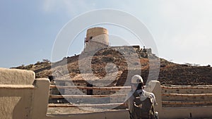 Photographer taking photo of a fort of Hatta heritage village in Hatta town of Dubai emirate in the UAE