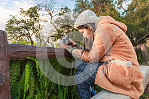 Photographer taking photo of landscape from top of the mountain