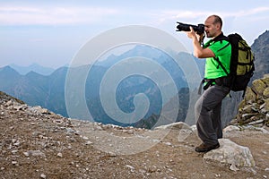 Photographer taking photo in the mountains