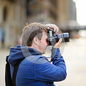 Photographer taking photo with professional digital camera