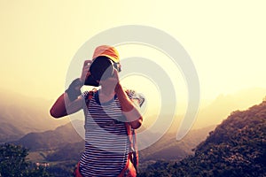 Photographer taking photo on top of mountain