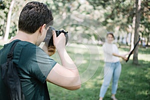 Photographer taking photos of blurred woman with reflector
