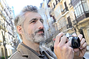 Photographer taking photos in city street