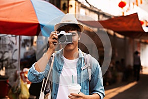 Photographer taking photos of lively streets with restaurants