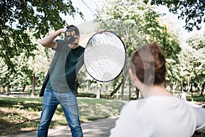 Photographer taking photos of out of focus female model