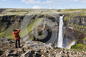 Photographer taking picture of Haifoss waterfall, Iceland