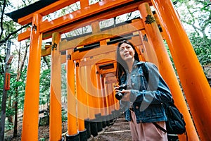 Photographer taking picture of Japanese red gate