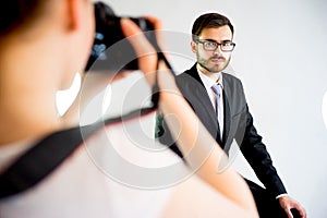 Photographer taking picture of a model in studio