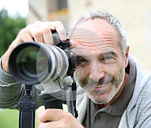 Photographer taking picture with modern camera